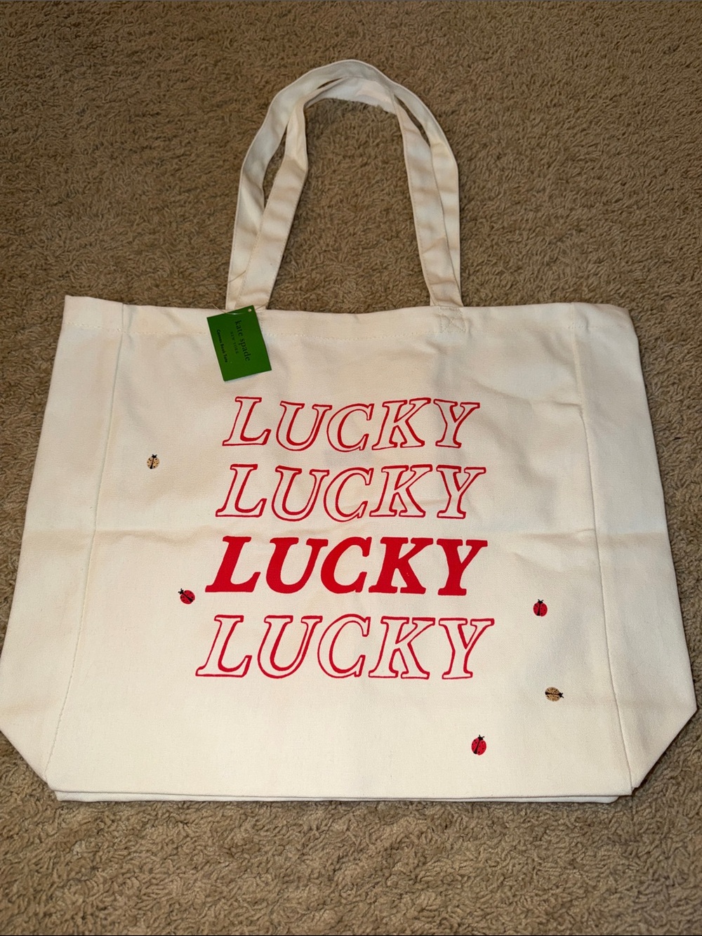 kate spade White Canvas Tote with Red 'LUCKY' Graphic